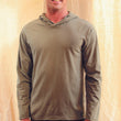 Load image into Gallery viewer, A fit young man wears a mushroom coloured hooded long sleeve pullover top. The hood is down.