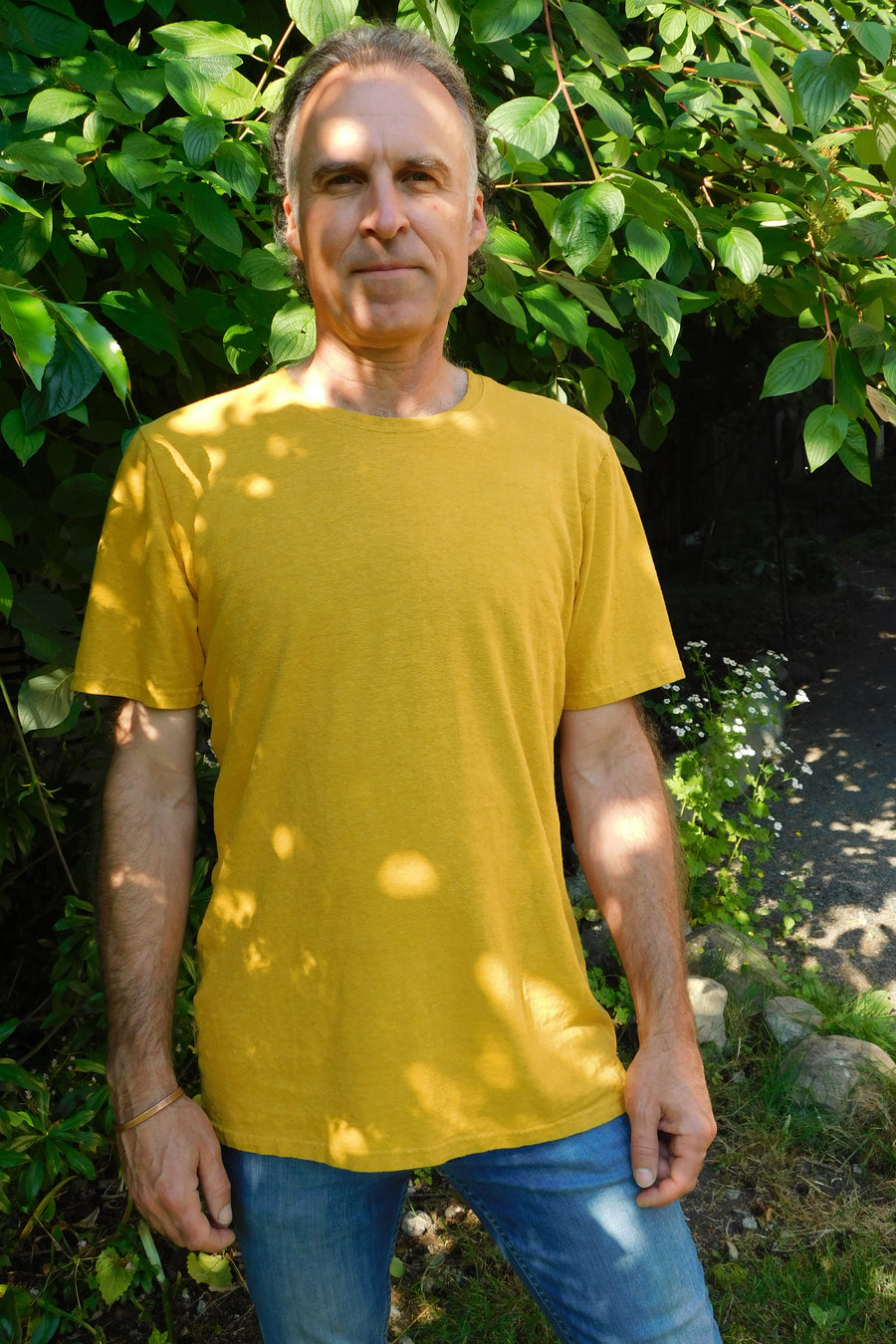 Male model wears a golden yellow short sleeve crew neck T-shirt 